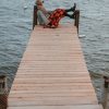 Young Woman Sitting On A Dock Looking Out To Water paint by numbers